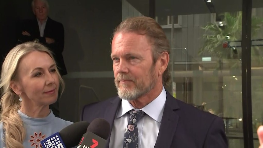 Craig McLachlan speaks to reporters in Sydney after the verdict, his partner Vanessa Scammell standing beside him.
