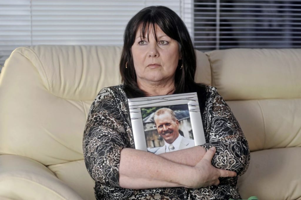 Kate Carroll holds a picture of her murdered husband Stephen Carroll in 2010