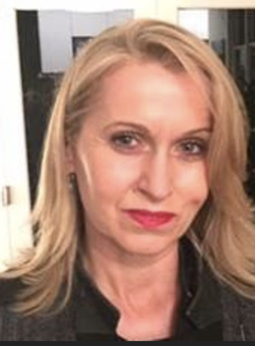 Tanya Smith SC, a woman with shoulder-length blonde hair in a dark jacket, in a close head-and-shoulders portrait.